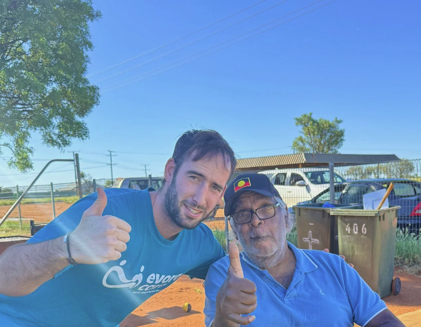 An Evora Care support worker and a participant giving the thumbs up together in community